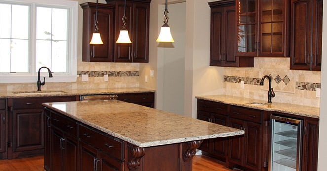 cherry upper and lower cabinets in newly remodeled kitchen with three separate countertops